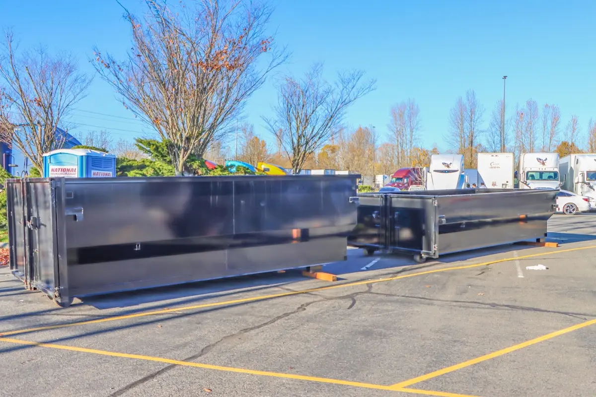 Professional dumpster rental service with roll-off container on residential driveway in Yonkers